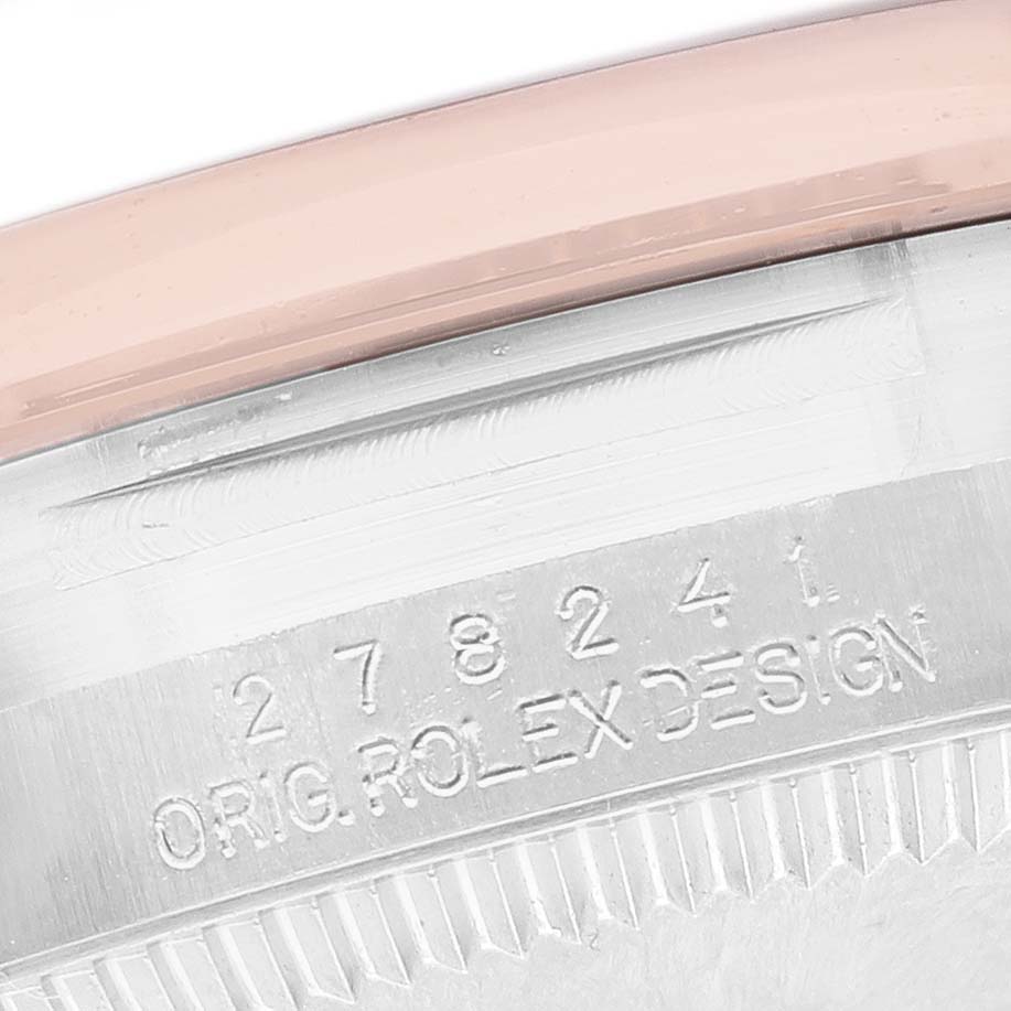 The image shows an angled view of the side of a Rolex Datejust 278241 Women's Steel and Gold (two tone) Yellow Dial, displaying its engraved model number and part of the bezel.