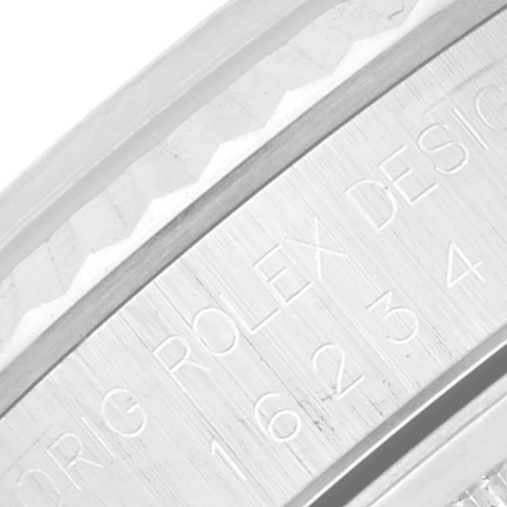 This is a close-up of the inner bezel of a Rolex Datejust 16234 Men's Stainless Steel Pink Dial 16234 Men's Stainless Steel Pink Dial watch, displaying the model number and "ROLEX DESIGN" engraving.