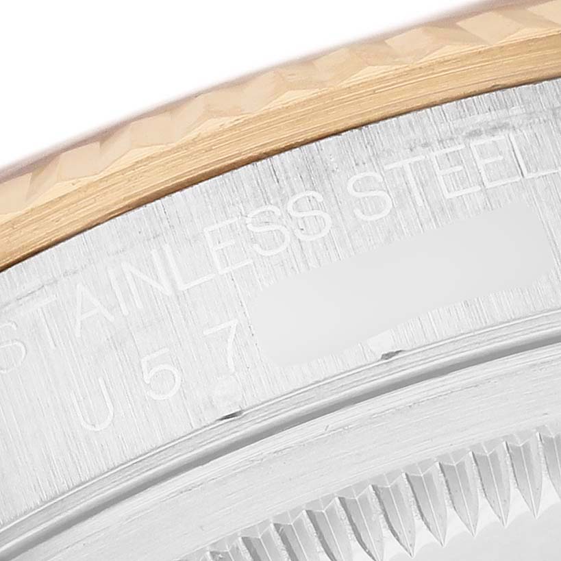 The image shows a close-up of the Rolex Datejust 16233 Men's Steel and Gold (two tone) Champagne Dial model's edge, highlighting the bezel and part of the case back with engravings.