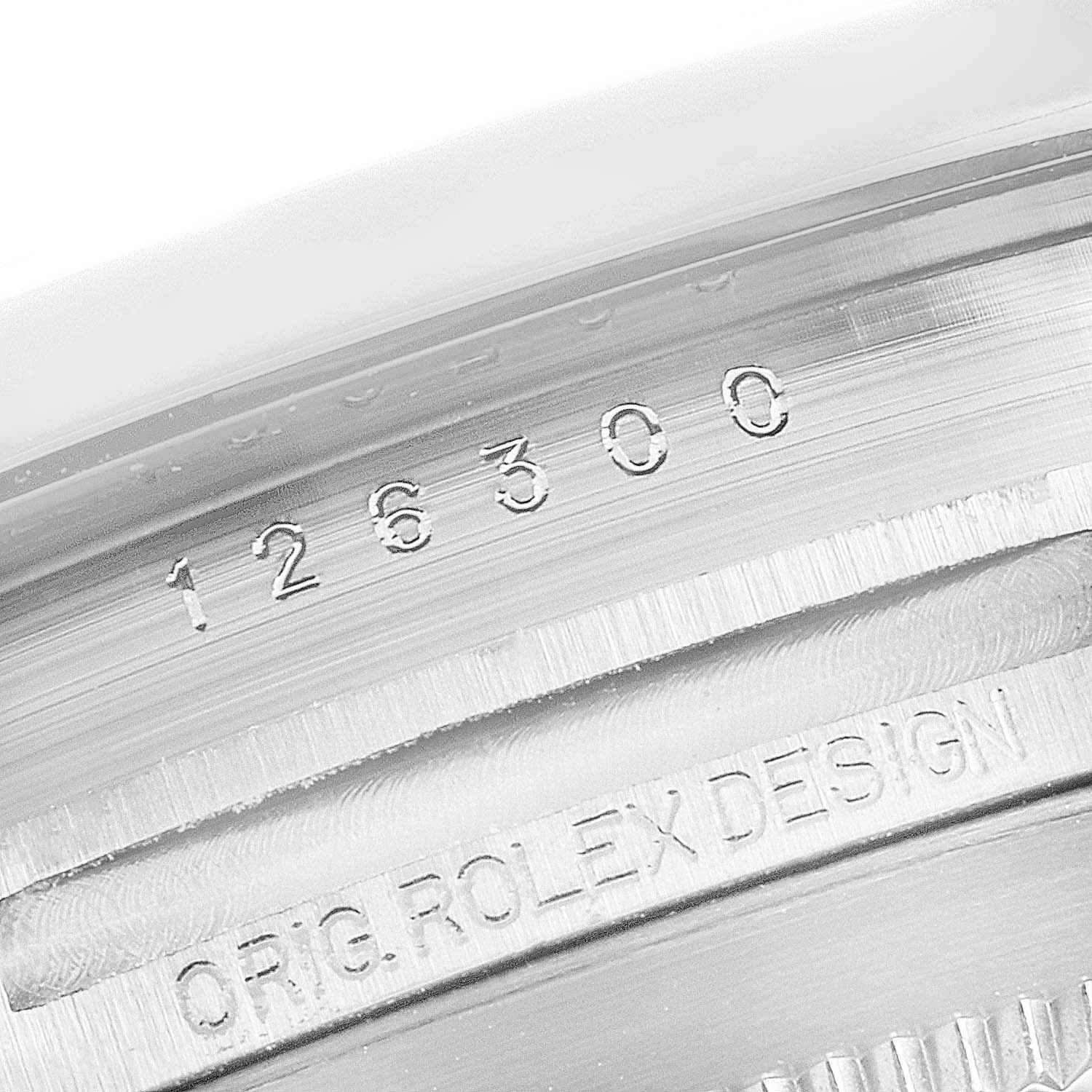 This image shows a close-up of the model number and "Rolex Design" engraving on the case of a Rolex Datejust 41 126300 Men
s Stainless Steel Grey Dial 126300 Men
s Stainless Steel Grey Dial watch.