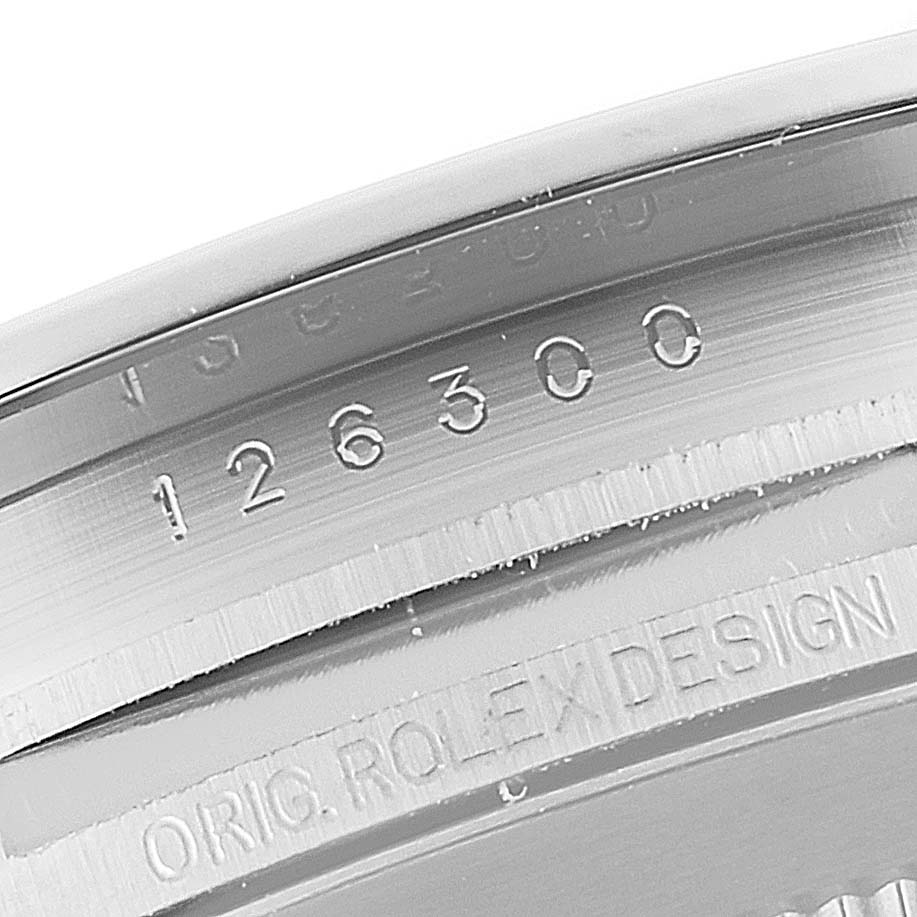 This close-up image of the Rolex Datejust 41 126300 Men
s Stainless Steel White Dial 126300 Men
s Stainless Steel White Dial model shows the inside of the watch case, featuring the model number and "ORIG. ROLEX DESIGN" engraving.
