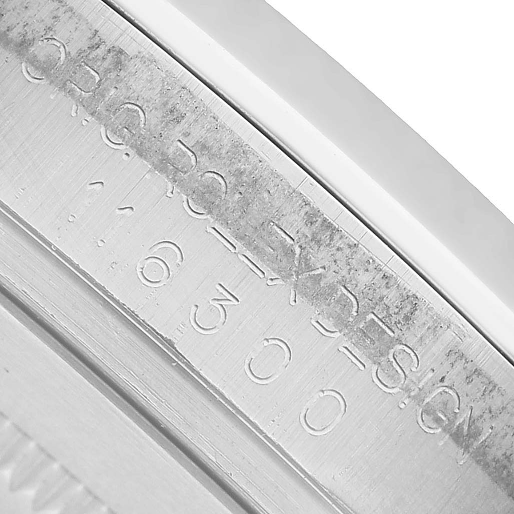 The image shows a close-up of the inner bezel engraving of a Rolex Datejust 41 116300 Men's Stainless Steel Blue Dial.
