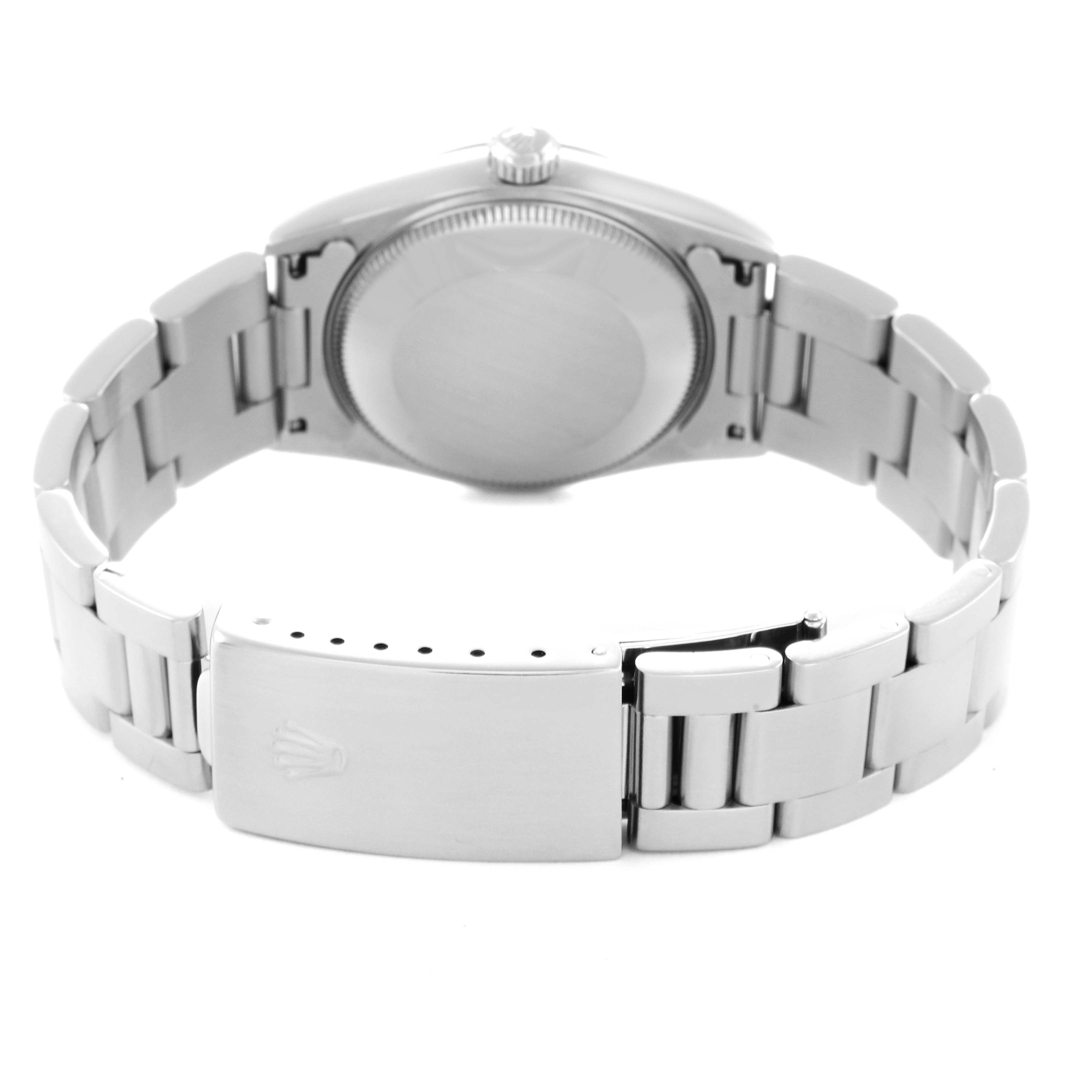 The Rolex Mid-Size 68240 Women
s Stainless Steel Black Dial 68240 Women
s Stainless Steel Black Dial watch is shown from the back, highlighting the clasp, bracelet, and case back.