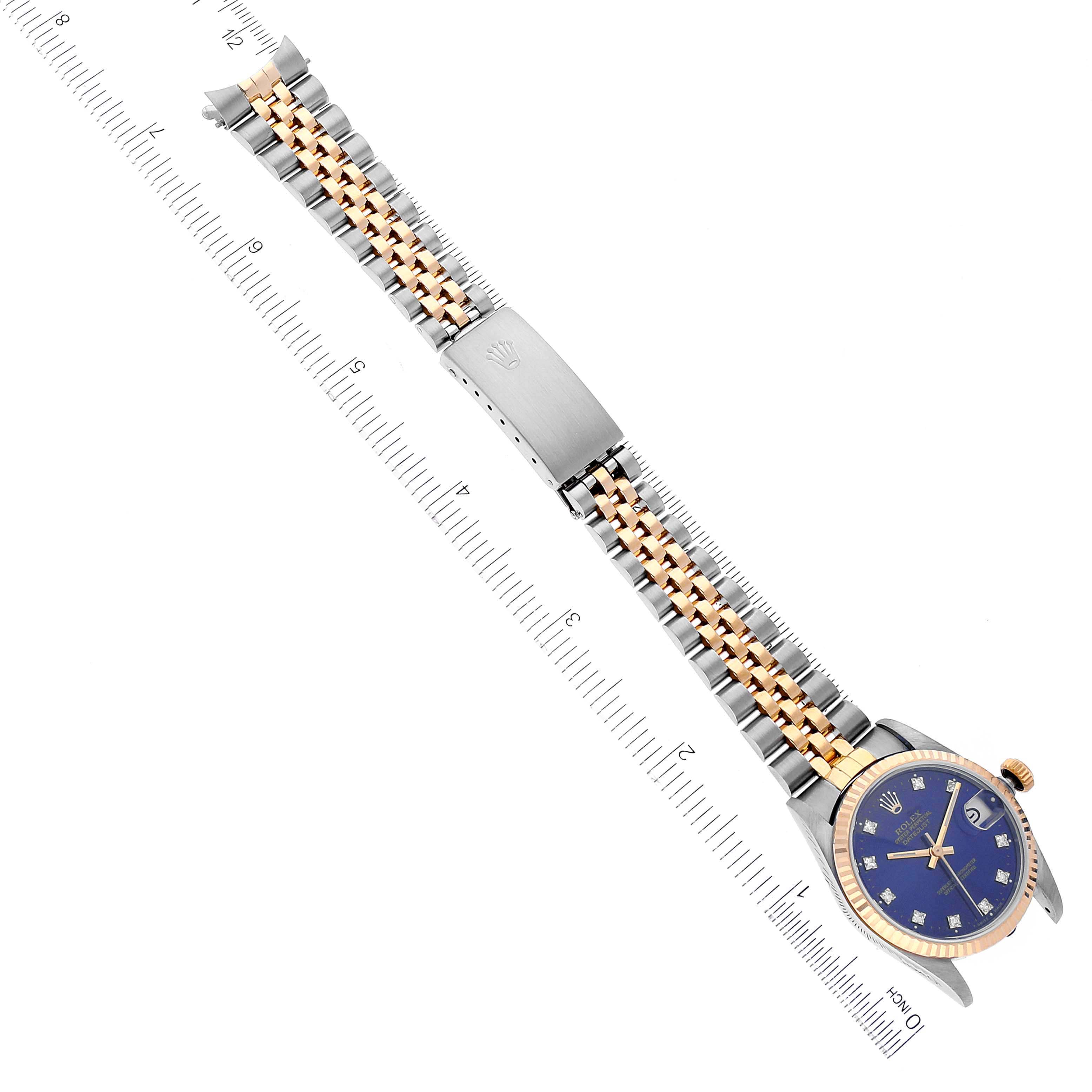 The image shows a top view of a Rolex Mid-Size 68273 Women
s Steel and Gold (two tone) Blue Dial 68273 Women
s Steel and Gold (two tone) Blue Dial model watch depicting its bracelet, clasp, and watch face.