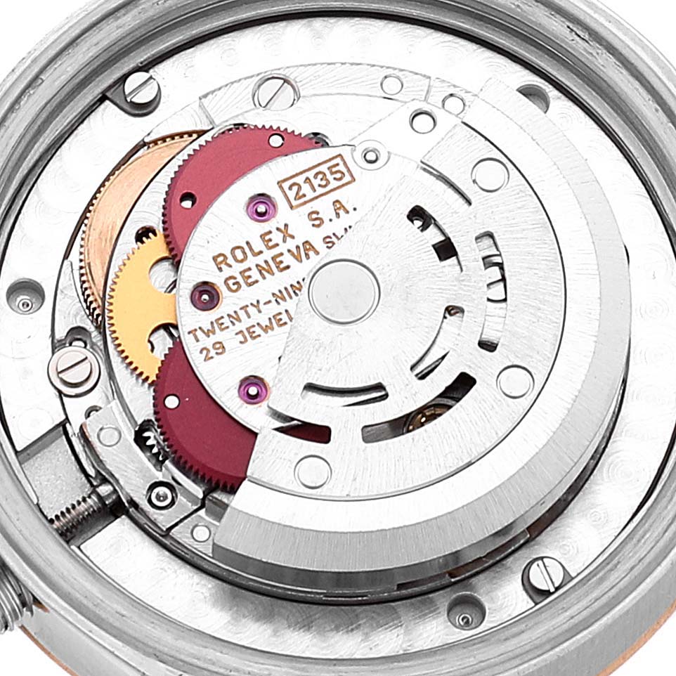 This close-up image shows the intricate internal mechanism of a Rolex Mid-Size 68273 Women
s Steel and Gold (two tone) Blue Dial 68273 Women
s Steel and Gold (two tone) Blue Dial watch, highlighting its movement and jewel components.