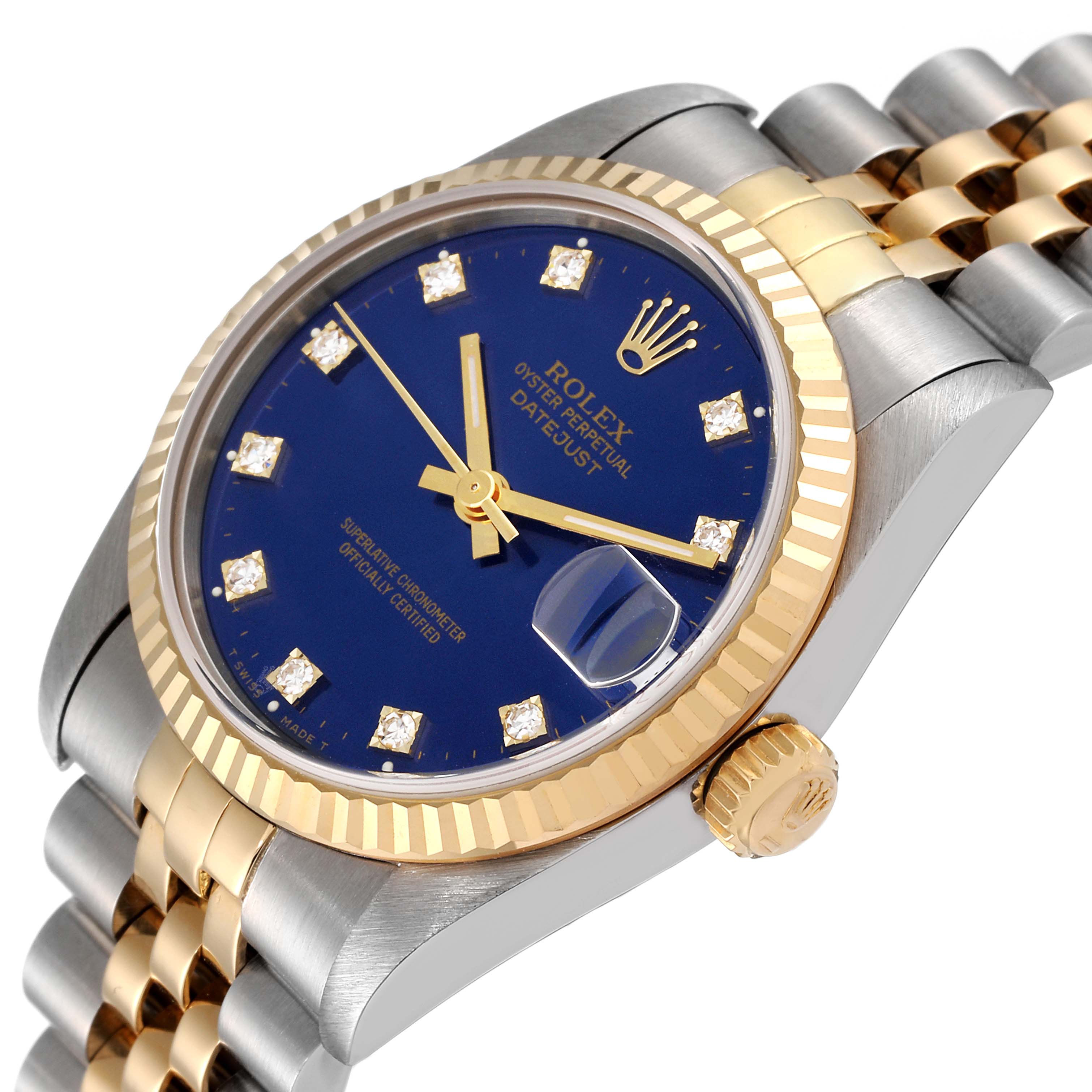 This image showcases a Rolex Mid-Size 68273 Women
s Steel and Gold (two tone) Blue Dial 68273 Women
s Steel and Gold (two tone) Blue Dial Datejust watch at an angle, highlighting the bezel, crown, blue dial, and part of the bracelet.
