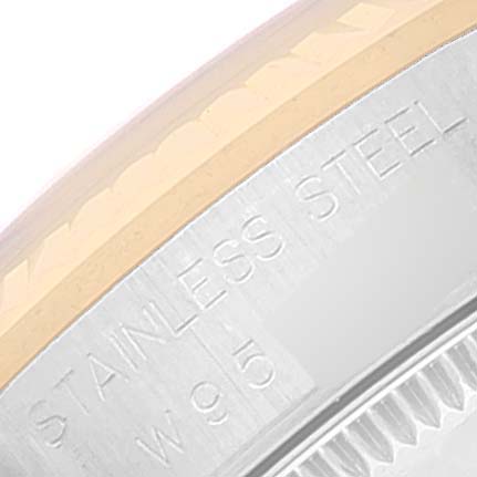 The image shows a close-up of the bezel and case side of a Mid-Size Rolex watch with "STAINLESS STEEL" engraved.