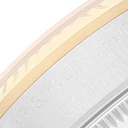 This close-up shows the side view of the casing and bezel of a Rolex Mid-Size 68273 Women
s Steel and Gold (two tone) Blue Dial 68273 Women
s Steel and Gold (two tone) Blue Dial model watch, highlighting engraved text.