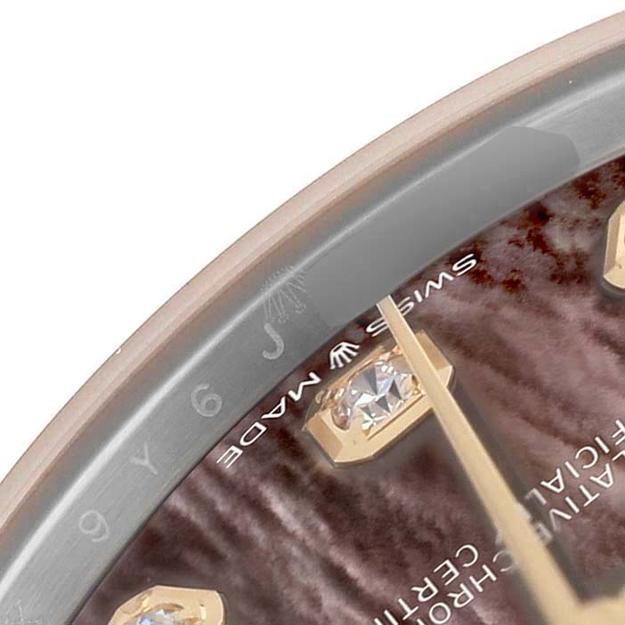 The close-up shows part of the dial and bezel of the Rolex Mid-Size 278273 Women's Steel and Gold (two tone) Mother of Pearl Dial model, highlighting a diamond hour marker and hands.