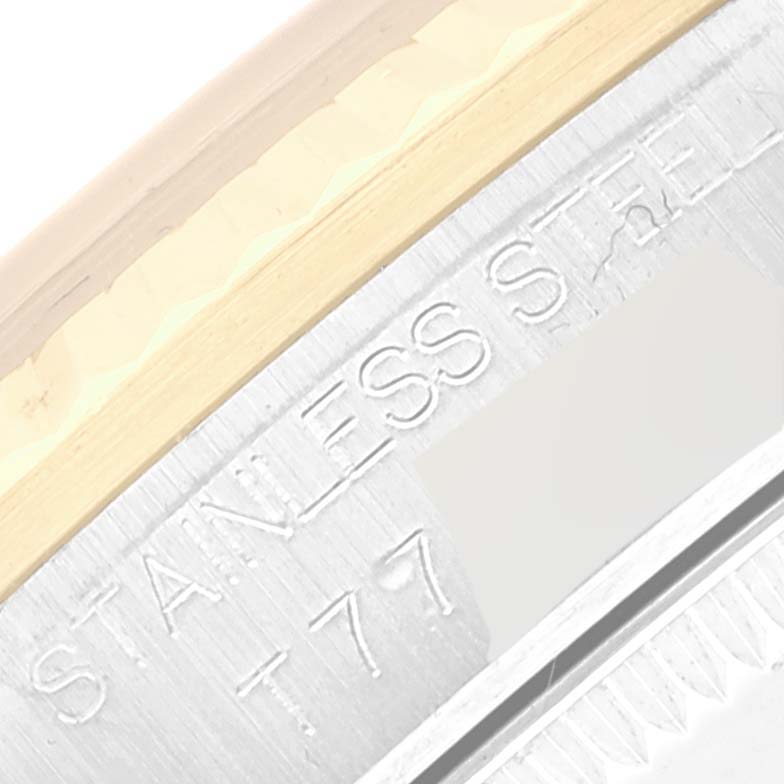 This image shows a close-up of the side engraving on a stainless steel mid-size Rolex watch.