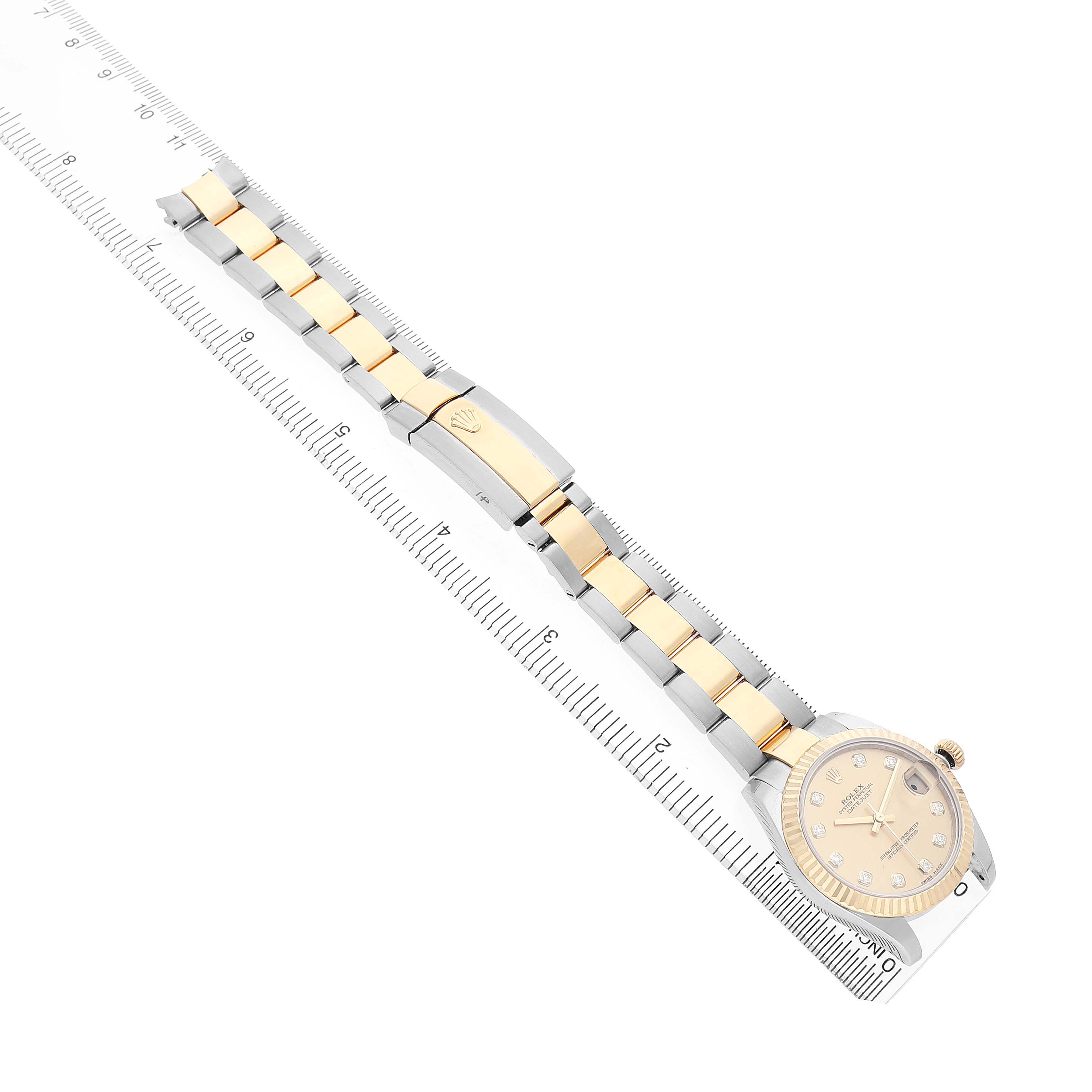 The Rolex Datejust 178273 Women's Steel and Gold (two tone) Champagne Dial watch is shown from an overhead angle, highlighting the bracelet and the clasp.