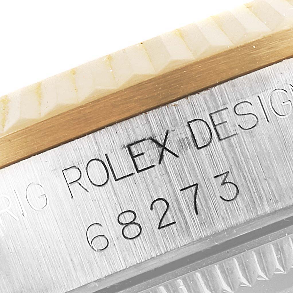 The image shows a close-up of the bezel and casing of a Mid-Size Rolex watch, with the model number "68273" engraved.