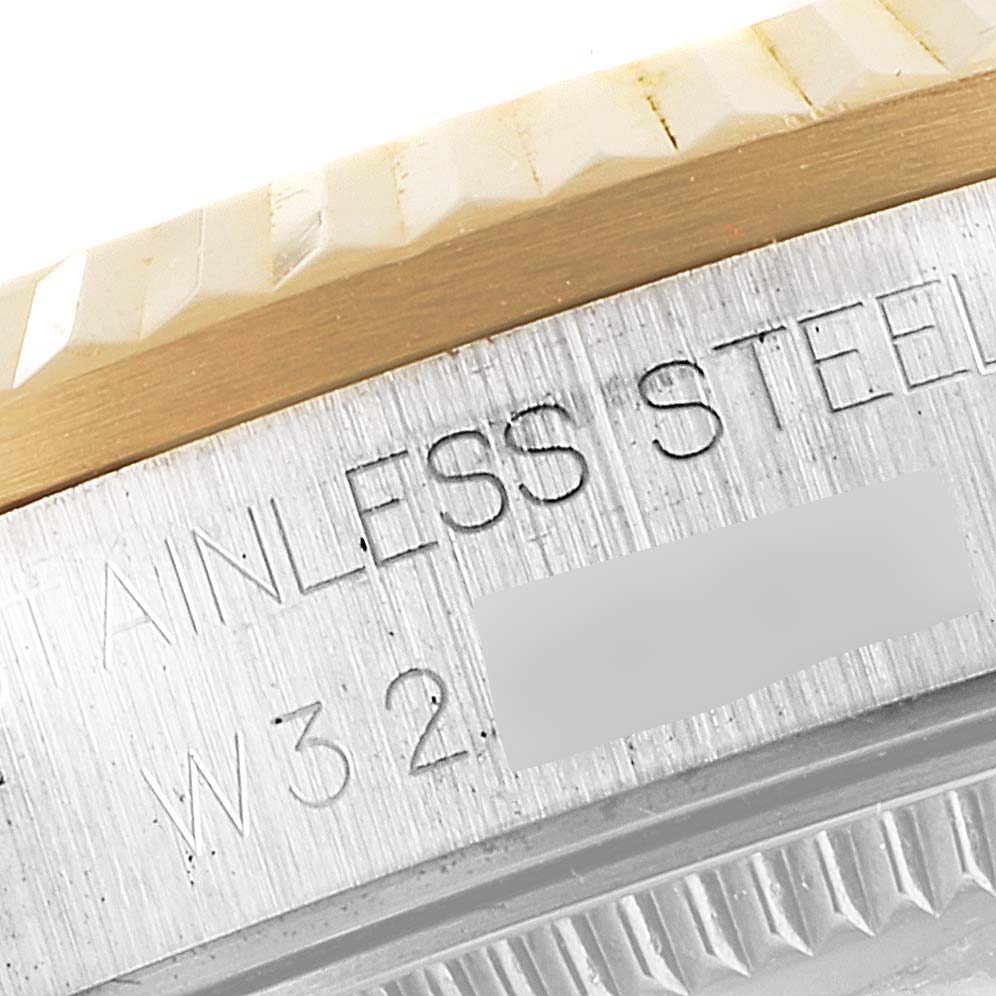 The image shows a close-up of the side of a Rolex Mid-Size 68273 Women's Steel and Gold (two tone) Mother of Pearl Dial 68273 Women's Steel and Gold (two tone) Mother of Pearl Dial model watch, focusing on the stainless steel and gold-toned bezel.