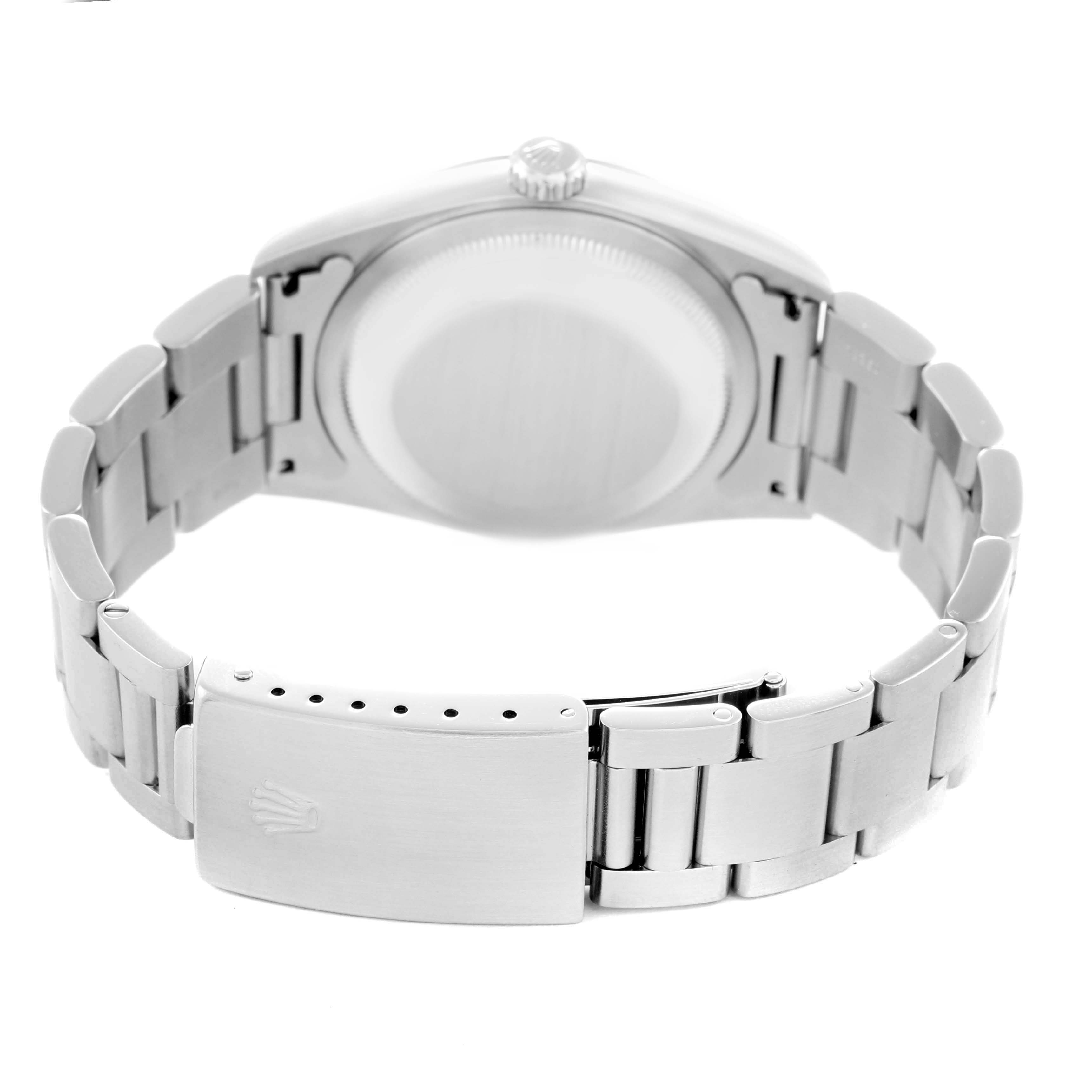 The Datejust Rolex watch is shown from the back, highlighting the bracelet and clasp.