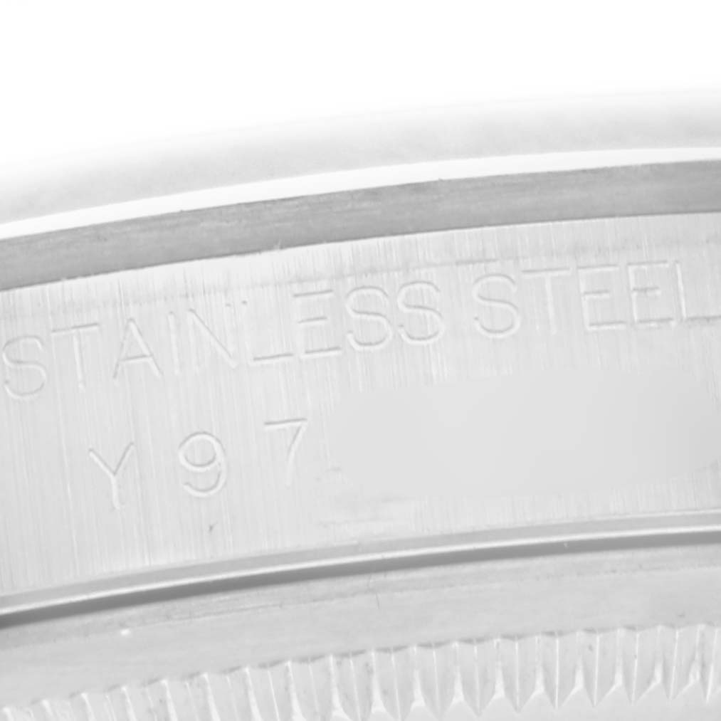 The image shows a close-up of the edge and engravings on the case back of a Rolex Datejust 16200 Men
s Stainless Steel Silver Dial 16200 Men
s Stainless Steel Silver Dial watch, highlighting "STAINLESS STEEL."