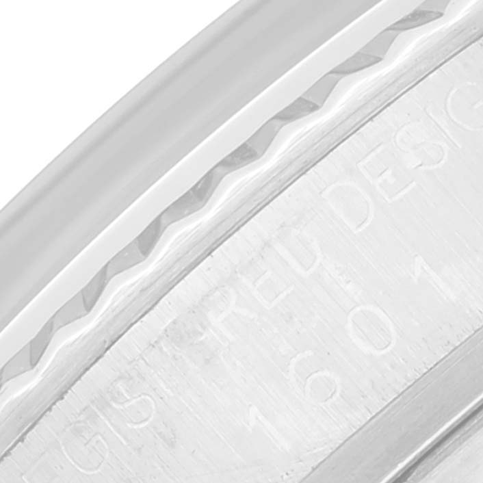 The image shows a close-up of the engraved side of the bezel and case of a Vintage Collection Rolex watch.