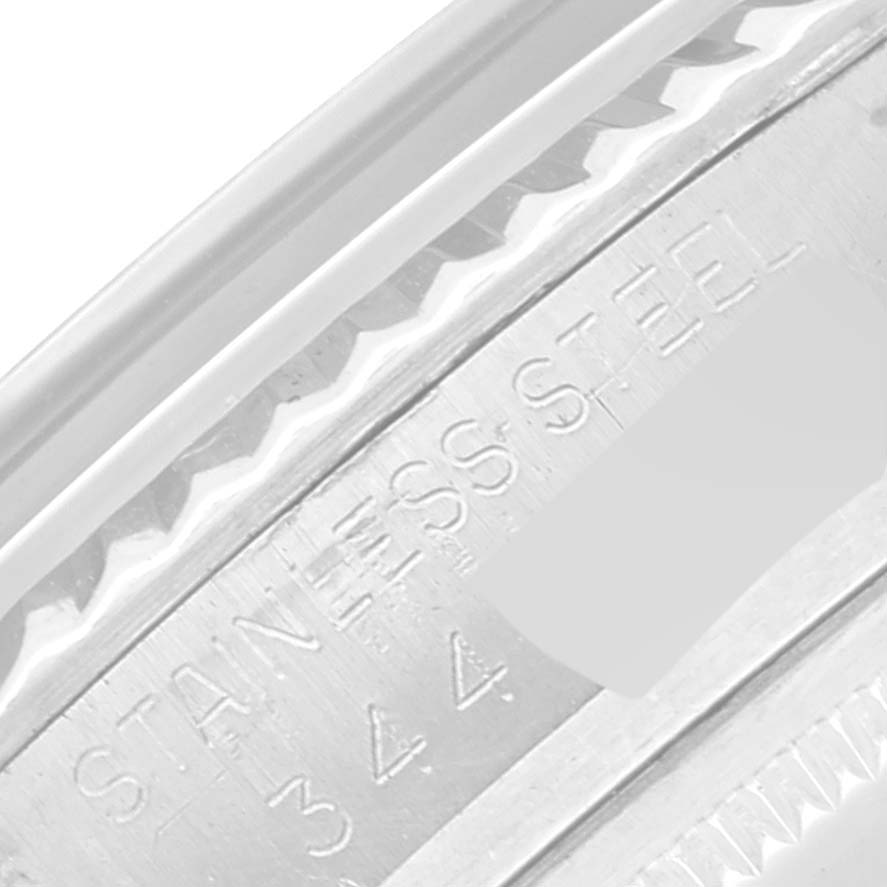 This is a close-up shot of the side engravings and bezel on a Rolex Vintage Collection 1601 Men's Stainless Steel Blue Dial 1601 Men's Stainless Steel Blue Dial watch.