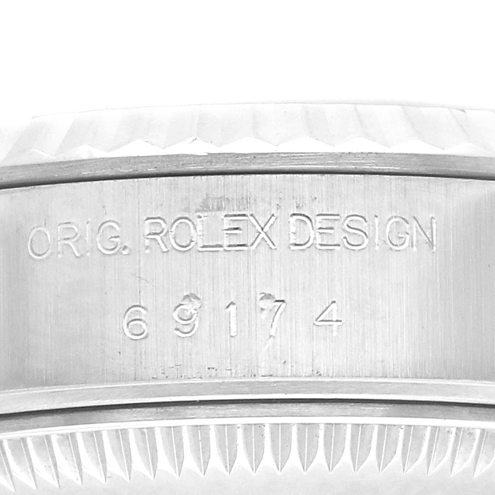 The image shows a close-up of the case side with engravings on a Rolex Datejust 71614 Women
s Stainless Steel Mother of Pearl Dial 71614 Women
s Stainless Steel Mother of Pearl Dial model.