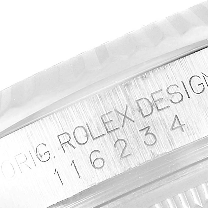 The image shows a close-up view of the serial number and engraving on the side of the bezel of a Rolex Datejust 116234 Men's Stainless Steel Silver Dial 116234 Men's Stainless Steel Silver Dial watch.