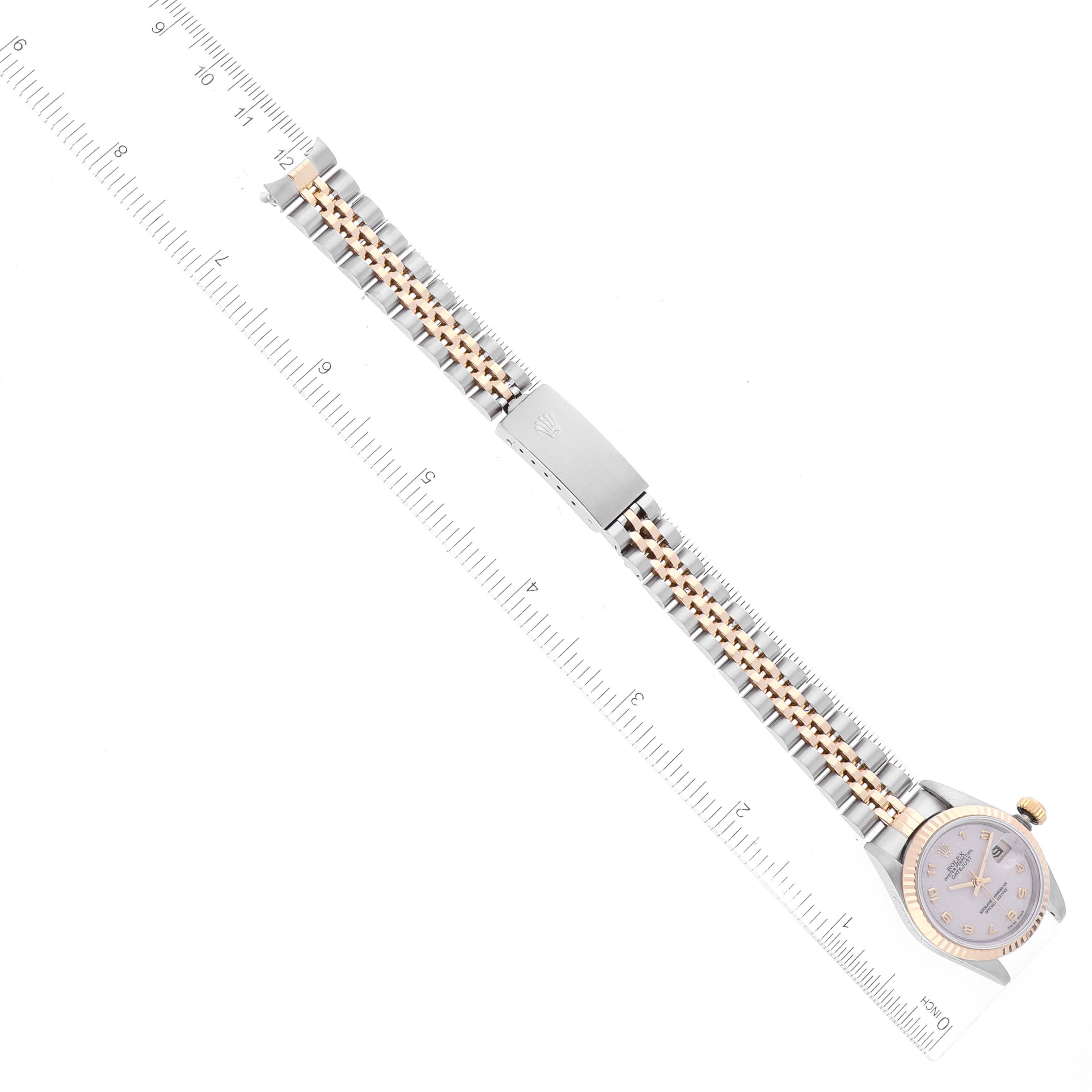 The image shows a top-down view of a Rolex Datejust 69173 Women's Steel and Gold (two tone) Beige Dial 69173 Women's Steel and Gold (two tone) Beige Dial watch, highlighting its bracelet, clasp, and part of the case against a measuring ruler.