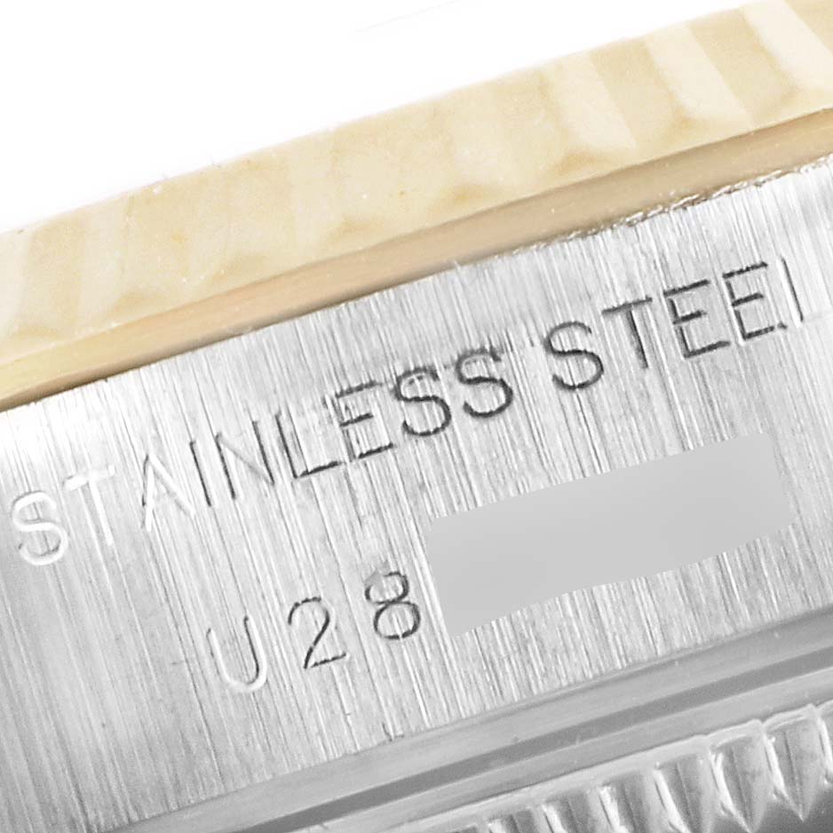 The image shows a close-up of the stainless steel case side of a Rolex Datejust 69173 Women's Steel and Gold (two tone) Champagne Dial 69173 Women's Steel and Gold (two tone) Champagne Dial watch, highlighting the engraved text.