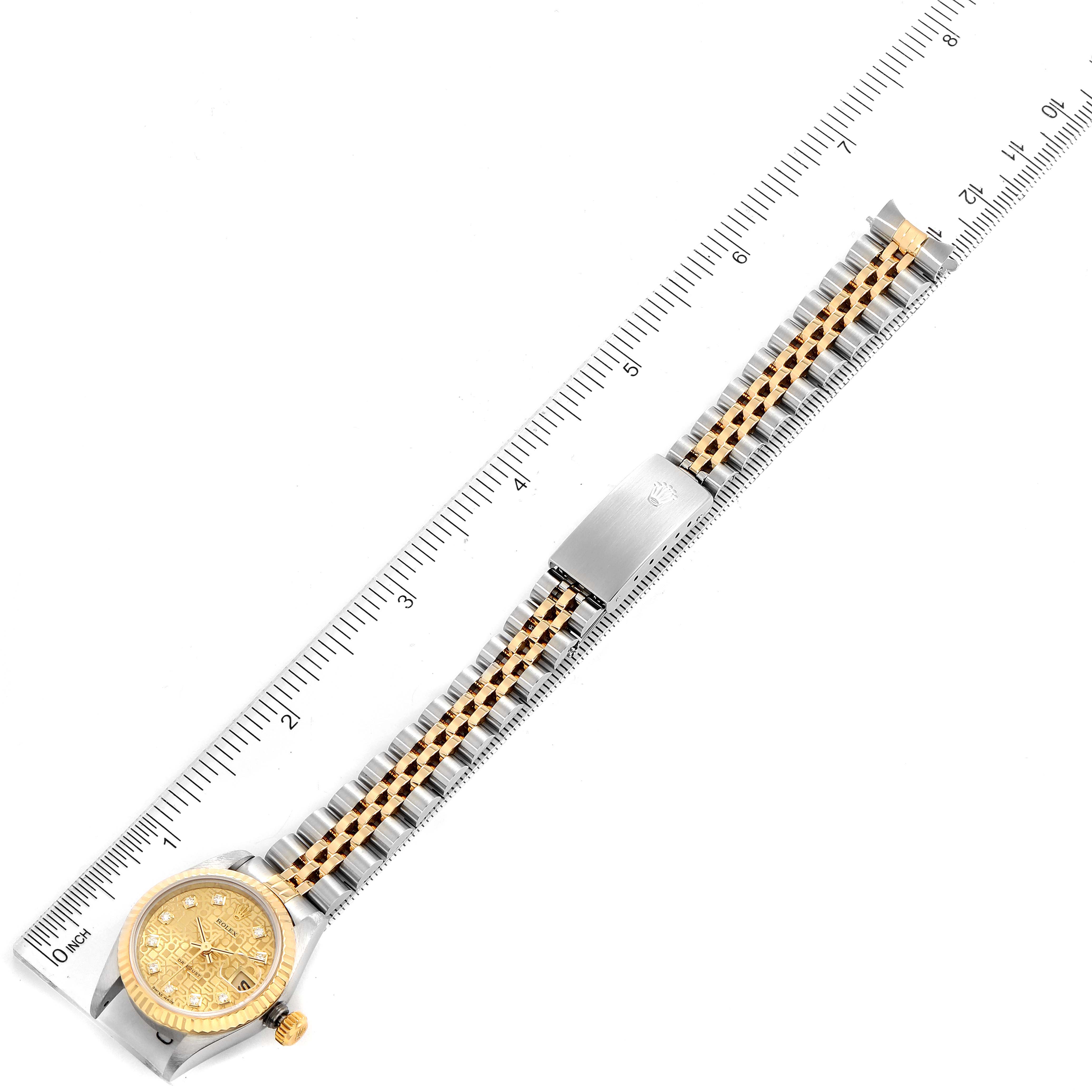 This image shows a Rolex Datejust 69173 Women's Steel and Gold (two tone) Champagne Dial 69173 Women's Steel and Gold (two tone) Champagne Dial watch placed next to a ruler, highlighting the watch's face, bracelet, and clasp.