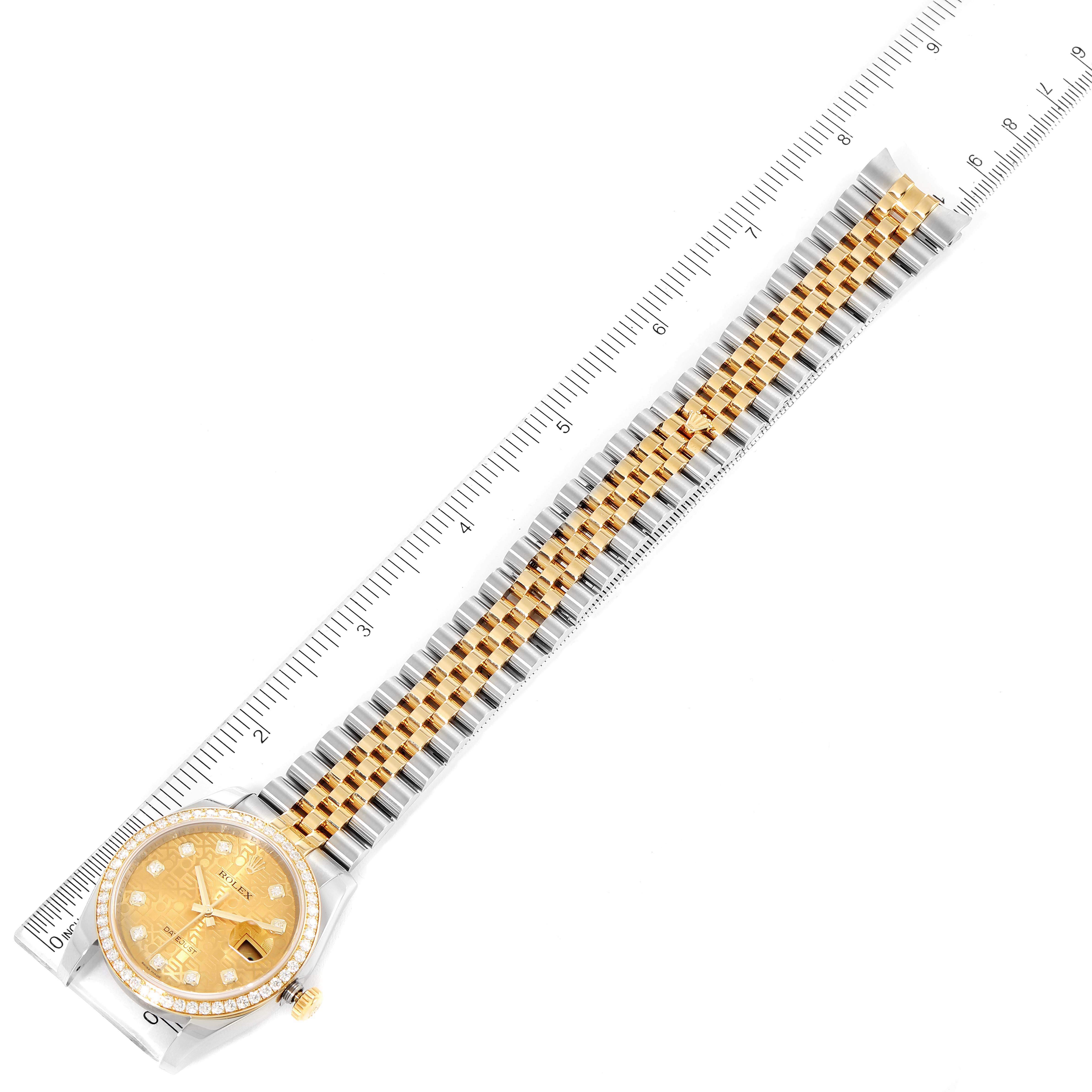 This image shows a top-down view of a Rolex Datejust 116243 Men's Steel and Gold (two tone) Champagne Dial 116243 Men's Steel and Gold (two tone) Champagne Dial watch with its full bracelet laid alongside a ruler.