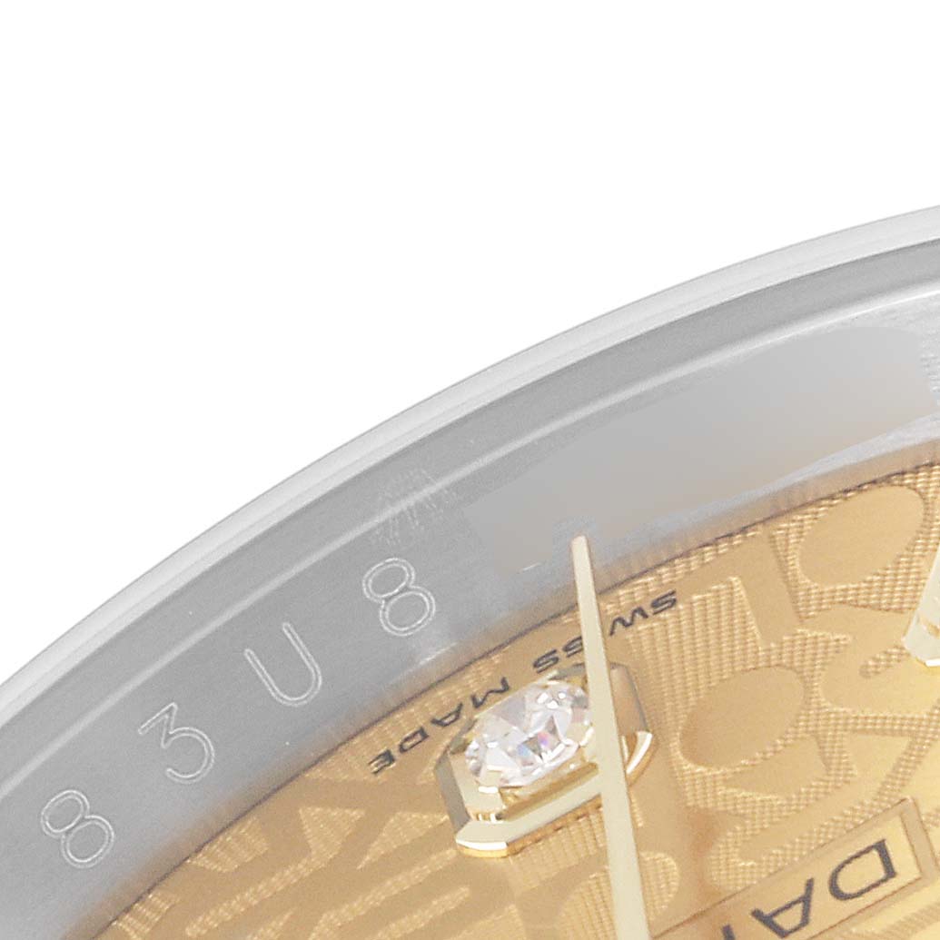 The image shows a close-up of the Datejust model by Rolex, focusing on the gold dial, diamond marker, and part of the rehaut with engravings.