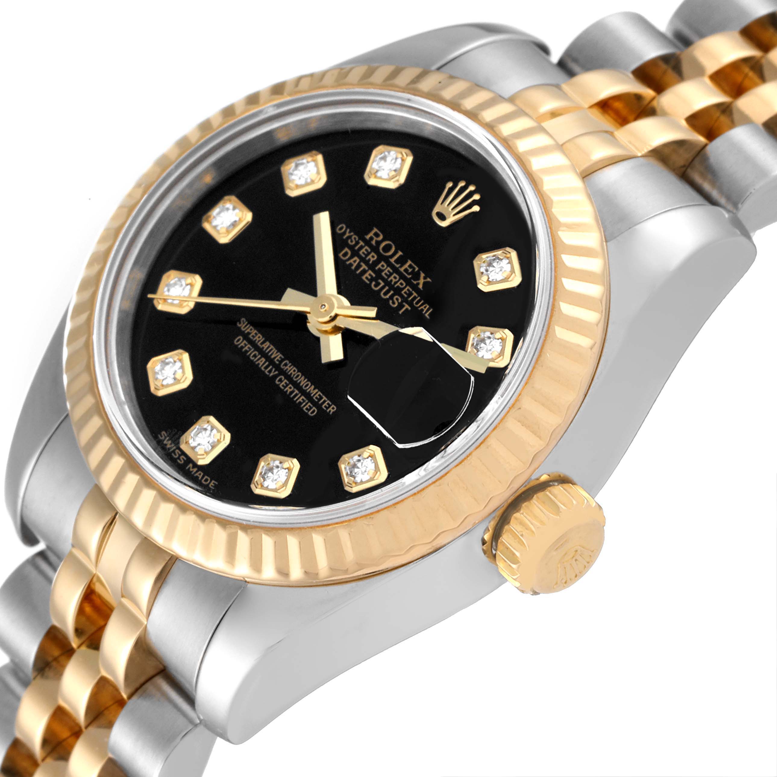 This image shows the Rolex Datejust 179173 Women's Steel and Gold (two tone) Black Dial 179173 Women's Steel and Gold (two tone) Black Dial watch at an angle highlighting its face, bezel, and part of the bracelet.