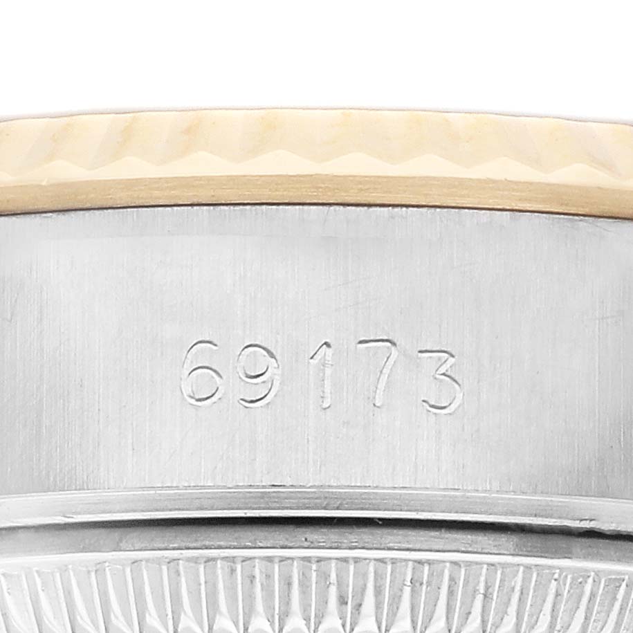 The image shows a close-up of the side and case number of a Rolex Datejust 79173 Women
s Steel and Gold (two tone) Champagne Dial 79173 Women
s Steel and Gold (two tone) Champagne Dial watch with a portion of the bezel.