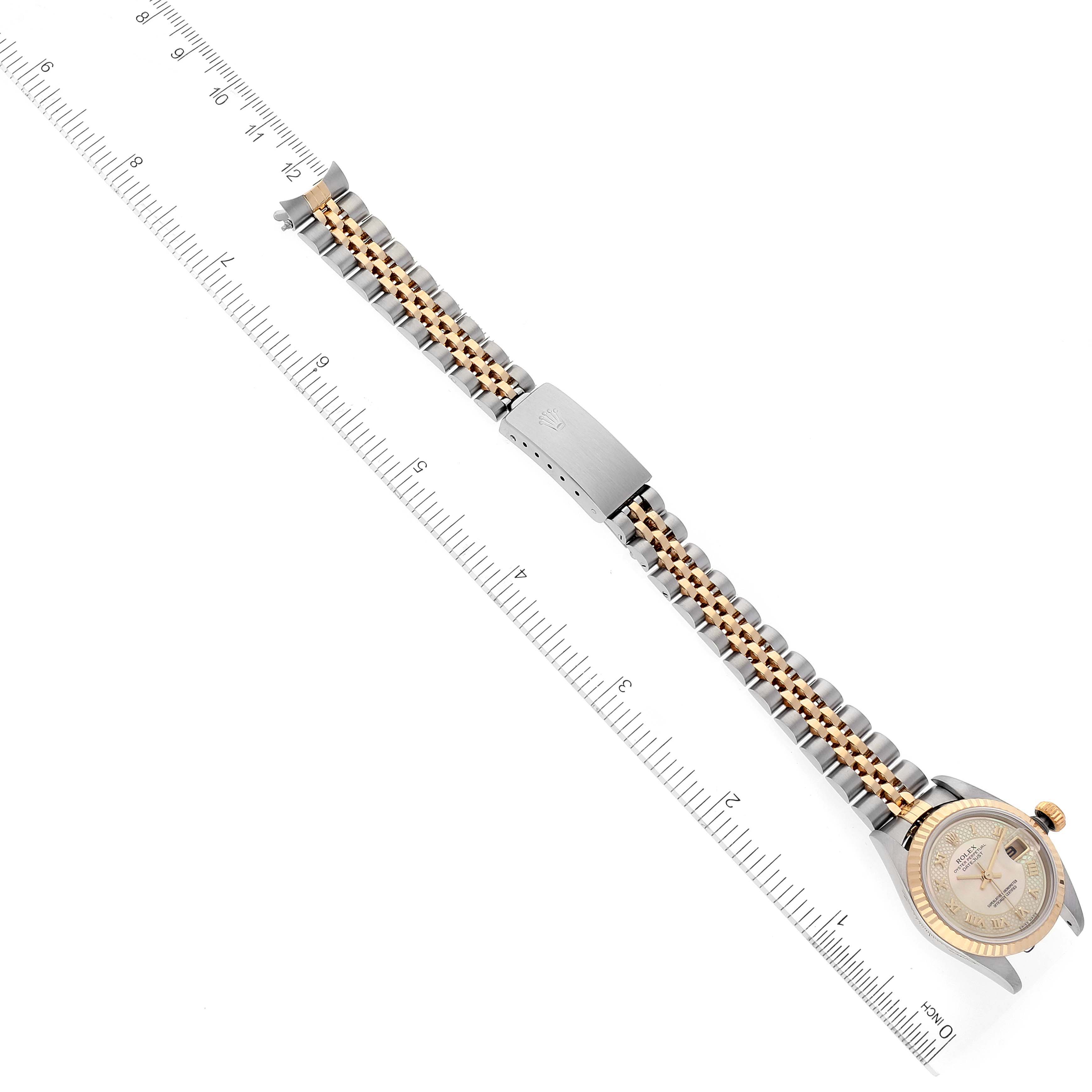 This image shows a side view of a Rolex Datejust 79173 Women's Steel and Gold (two tone) Mother of Pearl Dial 79173 Women's Steel and Gold (two tone) Mother of Pearl Dial watch, highlighting its watch face, metal bracelet, and clasp adjacent to a ruler for scale.