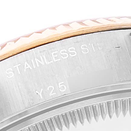 This close-up image of a Rolex Datejust 79173 Women's Steel and Gold (two tone) Mother of Pearl Dial 79173 Women's Steel and Gold (two tone) Mother of Pearl Dial watch shows a partial view of the case and fluted bezel, with "STAINLESS STEEL" and "Y25" inscribed.