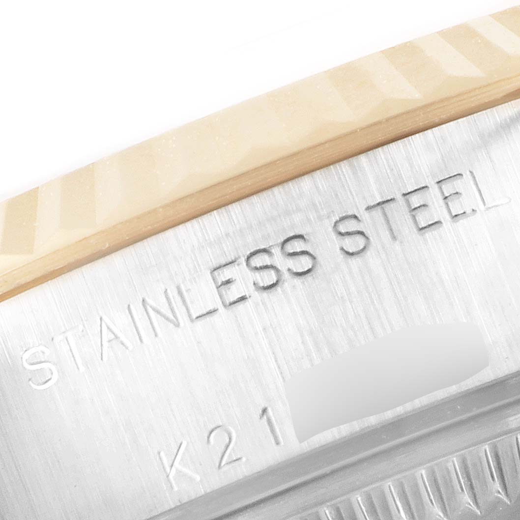 This image shows a close-up view of the stainless steel text engraved on the casing of a Rolex Datejust 79173 Women
s Steel and Gold (two tone) Champagne Dial 79173 Women
s Steel and Gold (two tone) Champagne Dial watch.