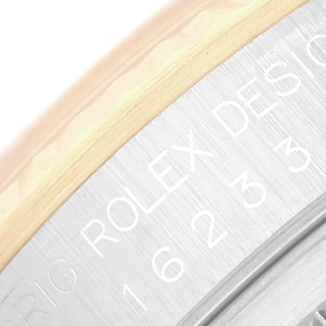 The image shows a close-up of the engraved text on the case side of a Rolex Datejust 16233 Men's Steel and Gold (two tone) Champagne Dial 16233 Men's Steel and Gold (two tone) Champagne Dial watch.
