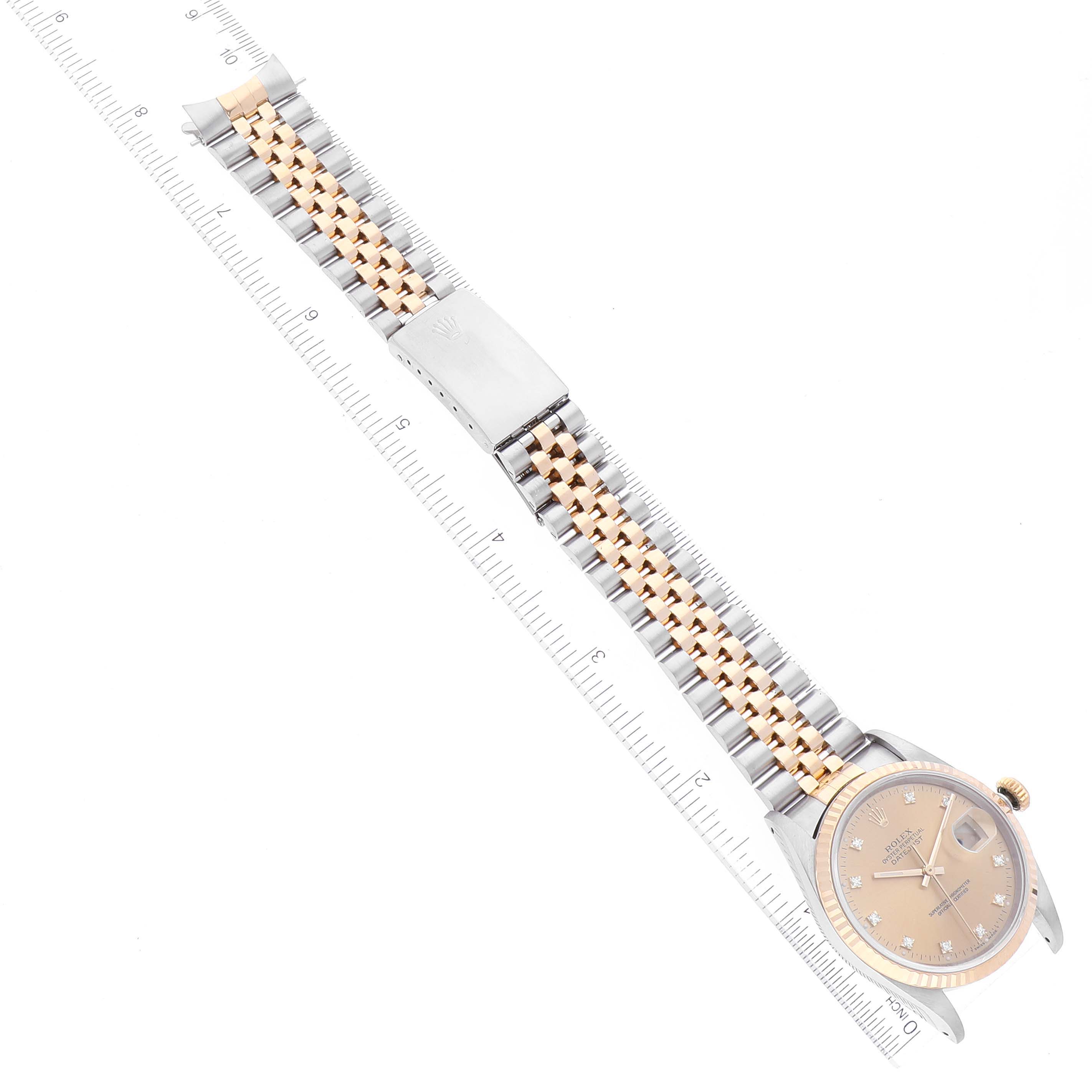 The image shows a Rolex Datejust 16233 Men's Steel and Gold (two tone) Champagne Dial 16233 Men's Steel and Gold (two tone) Champagne Dial watch laid flat with a ruler alongside the strap and clasp visible.
