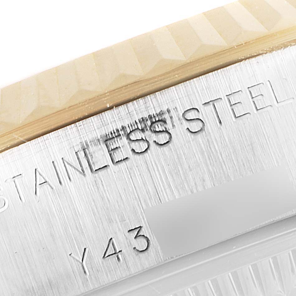 This close-up image shows the engraved stainless steel case and fluted bezel of a Rolex Datejust 79173 Women's Steel and Gold (two tone) Mother of Pearl Dial 79173 Women's Steel and Gold (two tone) Mother of Pearl Dial watch.