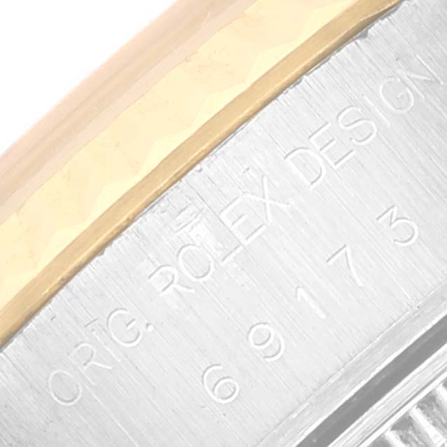 This close-up angle shows the engraved text on the side of the bezel of a Rolex Datejust 69173 Women's Steel and Gold (two tone) White Dial 69173 Women's Steel and Gold (two tone) White Dial watch.