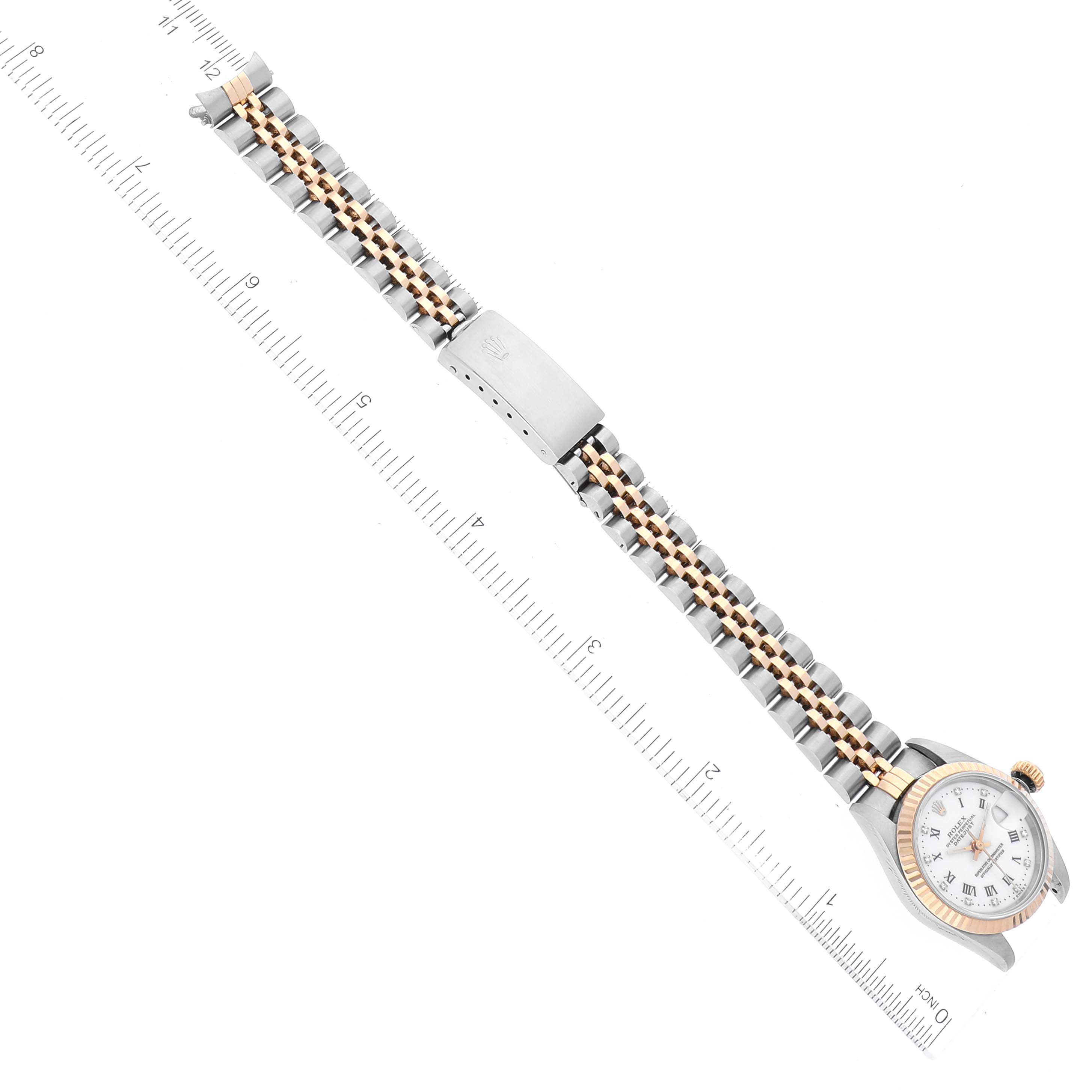 The image shows a top-down view of a Rolex Datejust 69173 Women's Steel and Gold (two tone) White Dial 69173 Women's Steel and Gold (two tone) White Dial watch, featuring its dial, bezel, crown, and two-tone bracelet.