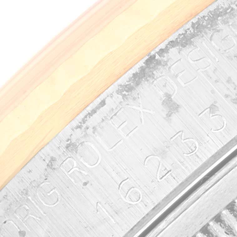 This image shows a close-up of the engraved details on the outer edge of a Rolex Datejust 16233 Men's Steel and Gold (two tone) White Dial 16233 Men's Steel and Gold (two tone) White Dial watch bezel.
