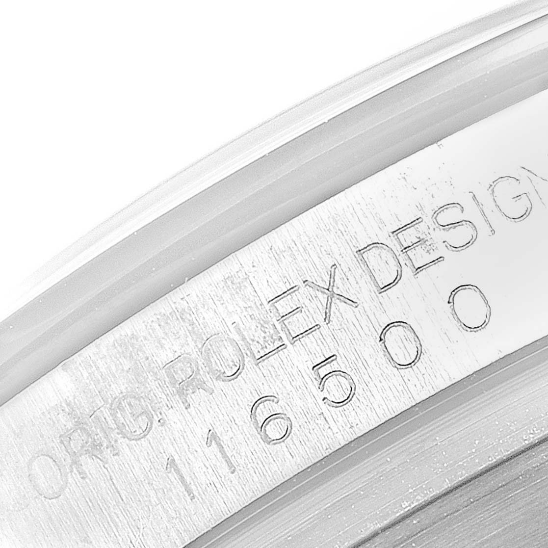 The image shows a close-up of the inner bezel inscription on a Rolex Daytona 116500 Men's Stainless Steel White Dial 116500 Men's Stainless Steel White Dial watch.