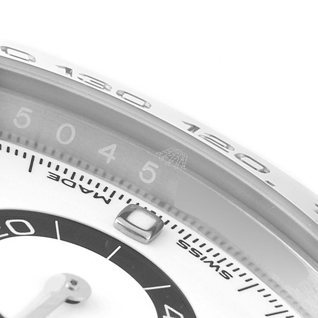 The image shows a close-up of the bezel and part of the dial of a Rolex Daytona 116500 Men's Stainless Steel White Dial 116500 Men's Stainless Steel White Dial watch.