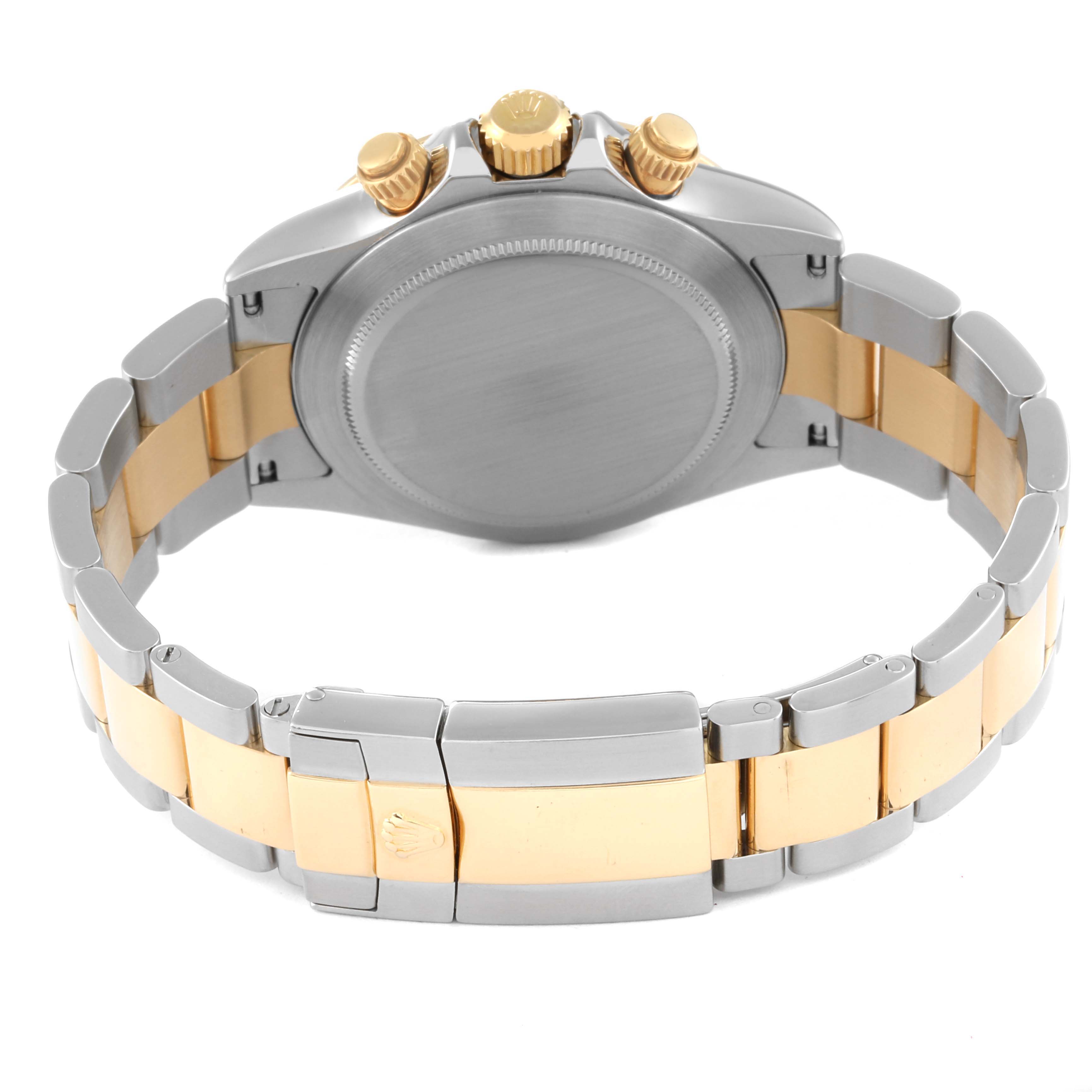 The image shows the back and clasp of a Rolex Daytona 116523 Men
s Steel and Gold (two tone) Black Dial 116523 Men
s Steel and Gold (two tone) Black Dial watch with a two-tone metal bracelet.