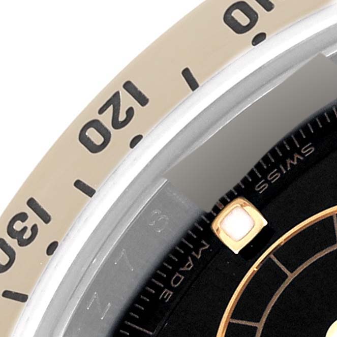 This image shows a close-up angle of the bezel and dial of a Rolex Daytona 116523 Men
s Steel and Gold (two tone) Black Dial 116523 Men
s Steel and Gold (two tone) Black Dial watch, highlighting numerals and part of the watch face.