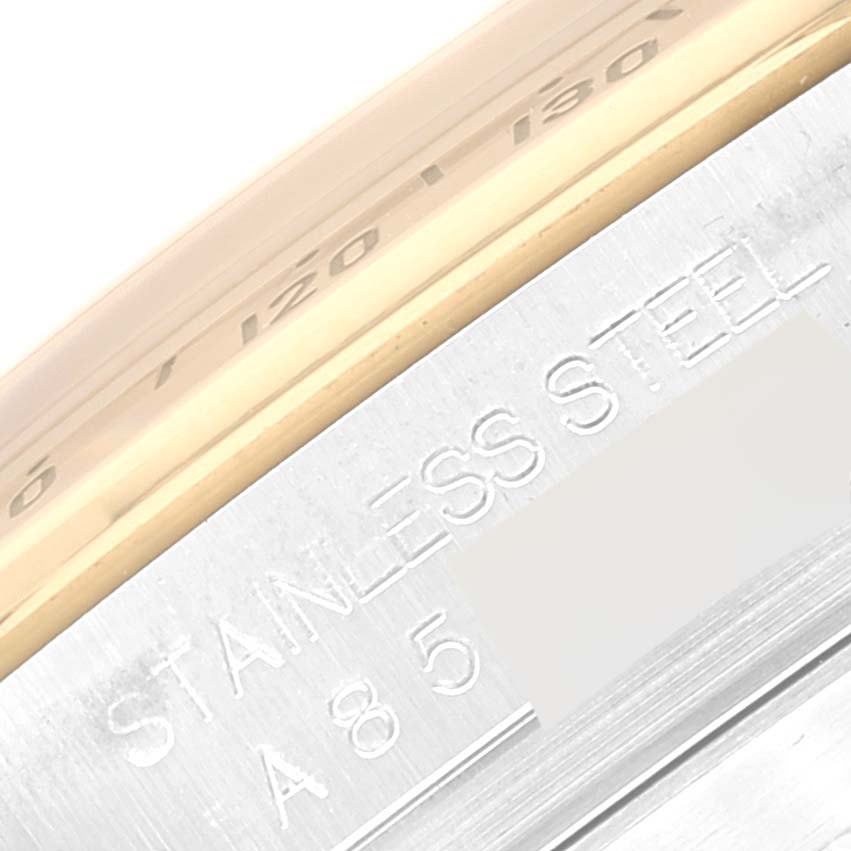 The image shows a close-up of the side engraving on a Rolex Daytona 16523 Men
s Steel and Gold (two tone) White Dial 16523 Men
s Steel and Gold (two tone) White Dial watch, highlighting its stainless steel material.