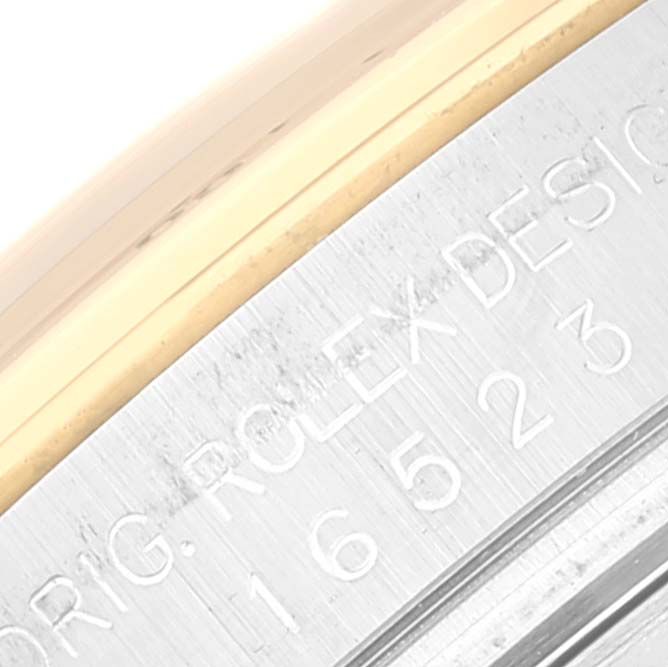 This image shows a close-up of the engraved bezel of a Rolex Daytona 16523 Men
s Steel and Gold (two tone) White Dial 16523 Men
s Steel and Gold (two tone) White Dial watch.