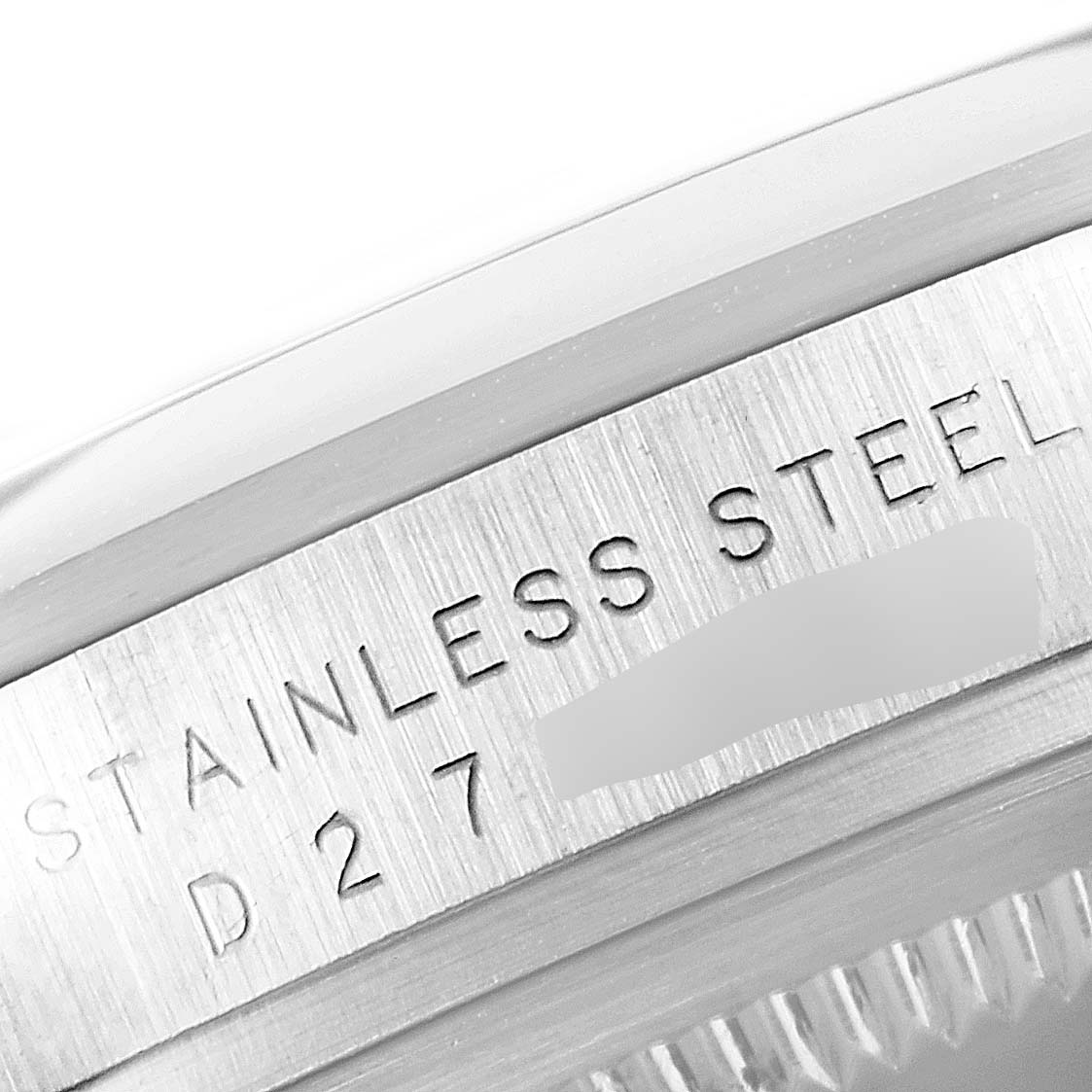 This close-up shows the engraved "STAINLESS STEEL" marking and serial number on the side of a Rolex Explorer 114270 Men's Stainless Steel Black Dial 114270 Men's Stainless Steel Black Dial watch case.