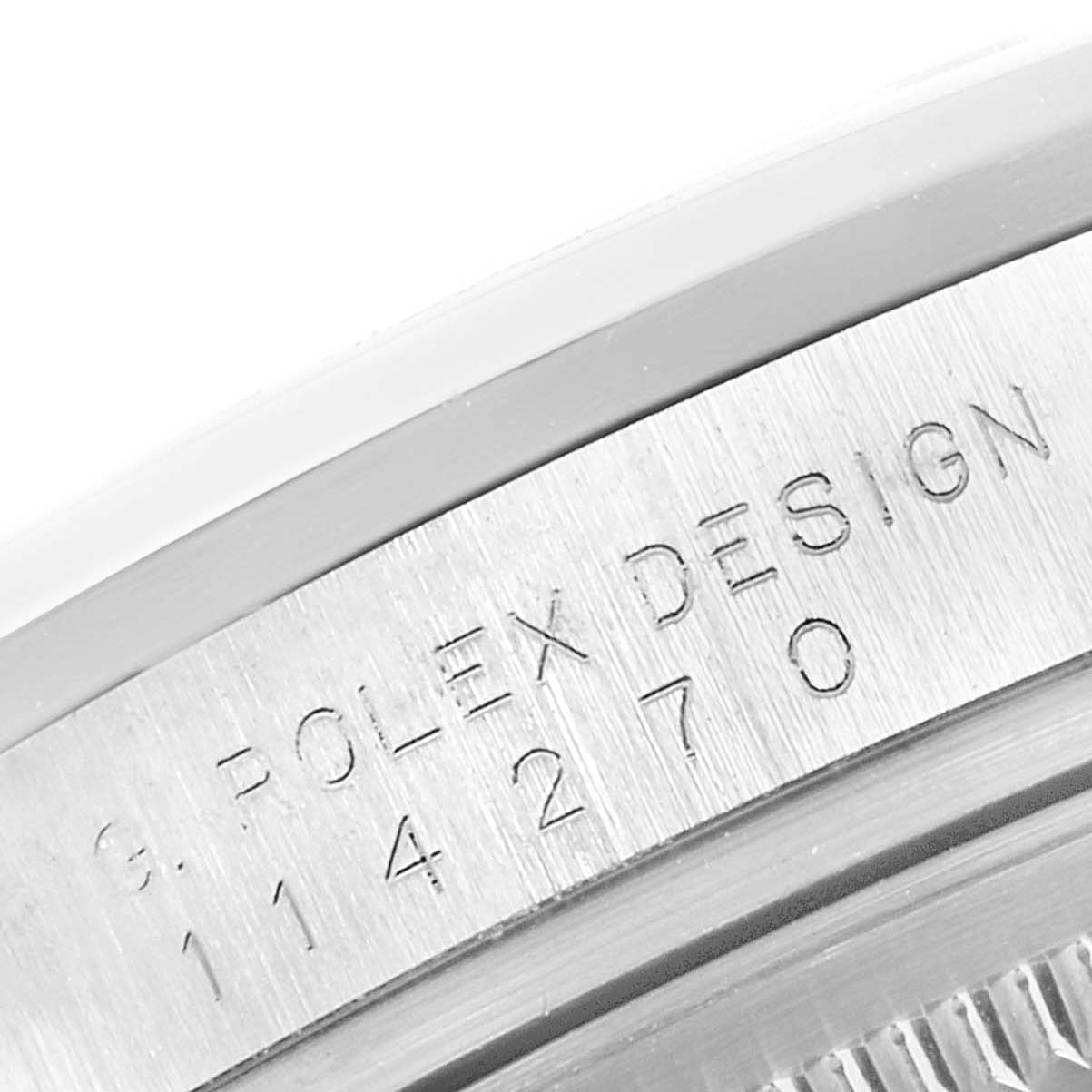The image shows a close-up of the side engraving on the case of a Rolex Explorer 114270 Men's Stainless Steel Black Dial 114270 Men's Stainless Steel Black Dial watch.