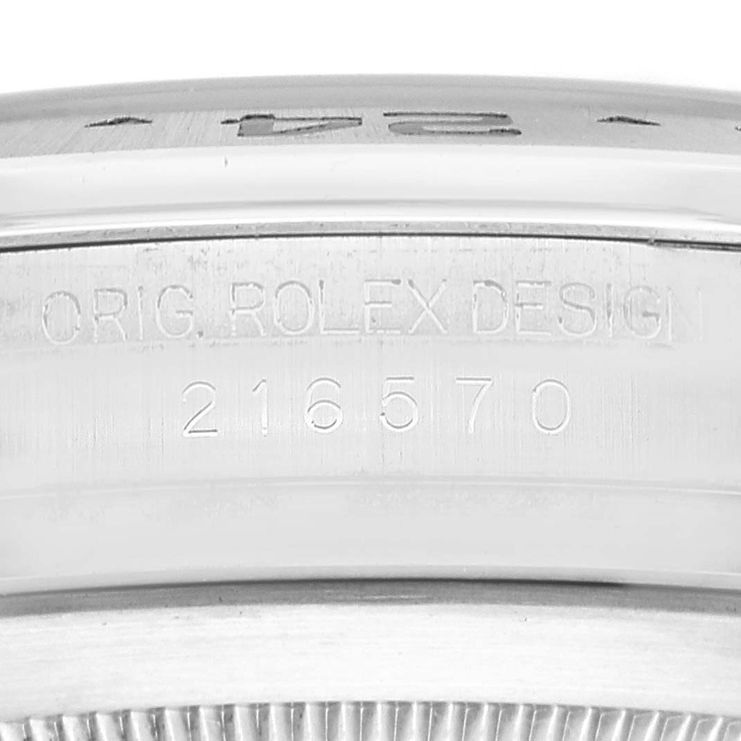 This image shows a close-up of the engraved serial number and "Orig. Rolex Design" text on a Rolex Explorer 216570 Men
s Stainless Steel Black Dial 216570 Men
s Stainless Steel Black Dial model 216570.