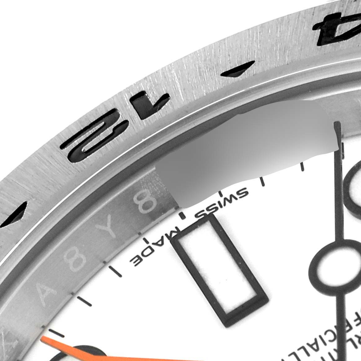 This close-up image shows part of the bezel and the dial face of a Rolex Explorer 216570 Men's Stainless Steel White Dial 216570 Men's Stainless Steel White Dial watch.
