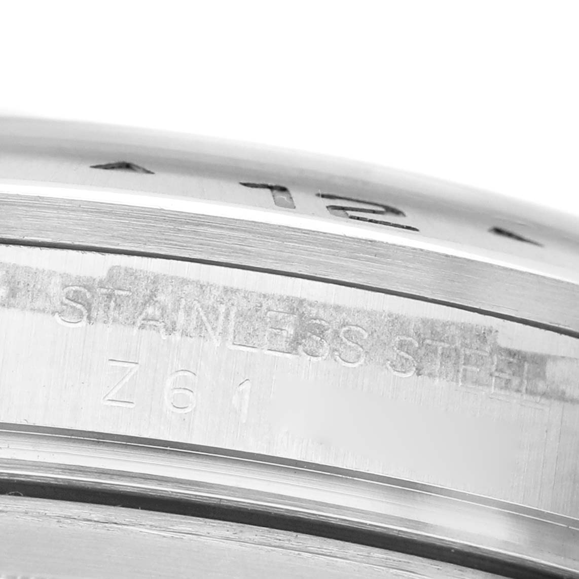 The image shows a close-up of the side of a Rolex Explorer 16570 Men's Stainless Steel Black Dial, highlighting the stainless steel engraving.